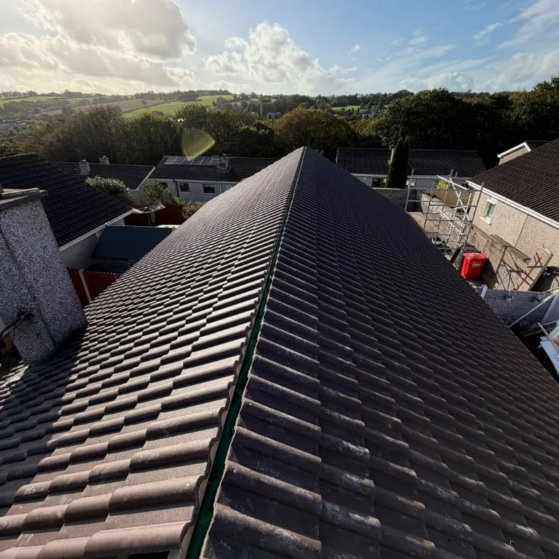 New roof tiles covering both pitches with the ridge line still open