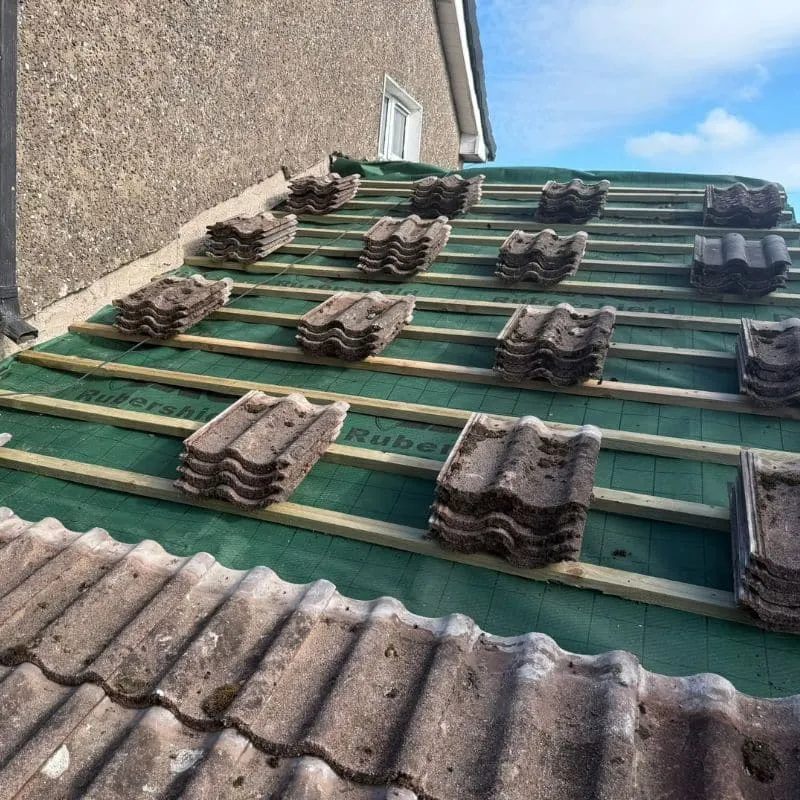 Existing roof tiles cleaned and stacked ready for re-laying on new roof in Ballincollig Cork