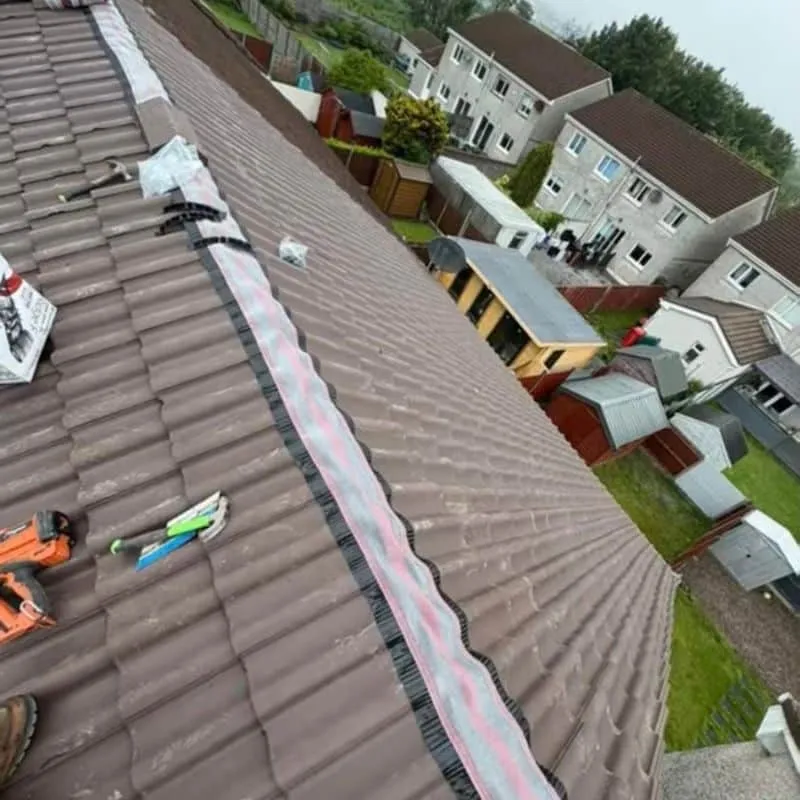 Two newly tiled roof slopes with the ridge area being finished on the Midleton house