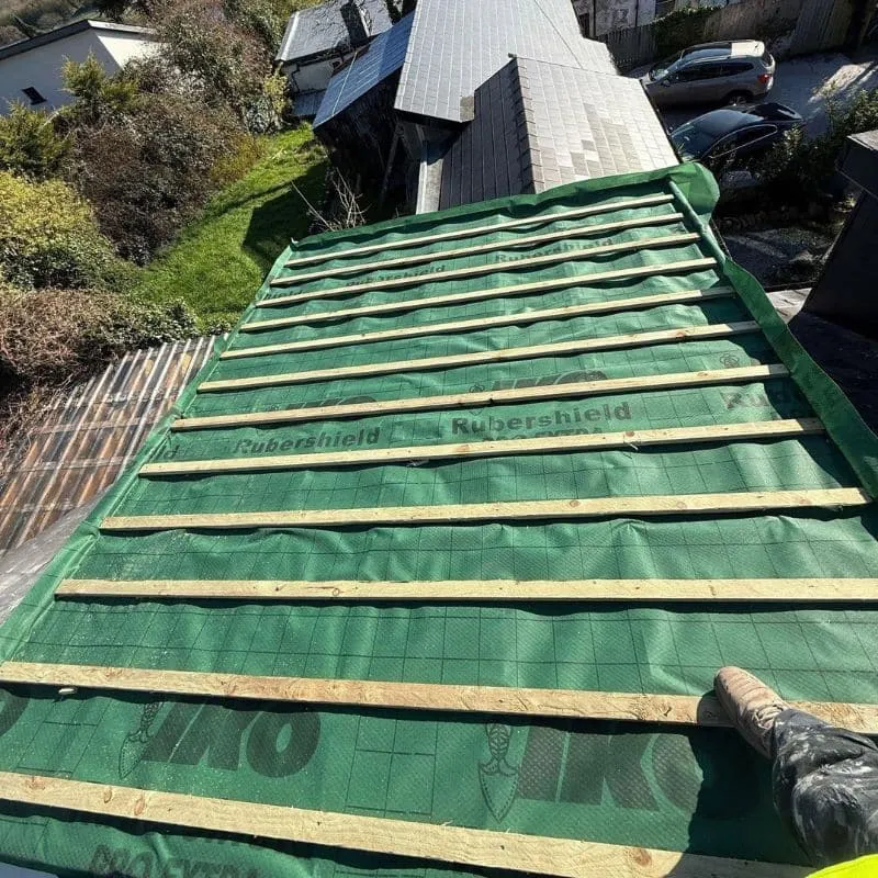 Green breathable roofing membrane and new timber battens fitted across a dormer roof